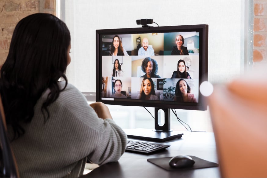 Businesswoman participates in virtual staff meeting on camera